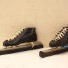 Classic black leather ice skates with shiny blades, embodying elegance and nostalgia for winter sports.