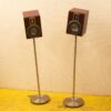 Sleek wooden speakers on metal stands, enhancing audio experience and modern interior style.