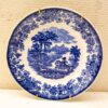 Serene blue transferware plate featuring a countryside scene with floral border and horseback rider.