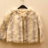 Stylish cropped creamy beige faux fur jacket with wide sleeves, perfect for versatile layering.