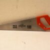 Stylish hand saw with stainless steel blade and ergonomic orange handle for precision cutting.
