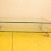 Sleek modern glass coffee table with chrome legs, perfect for contemporary living spaces.