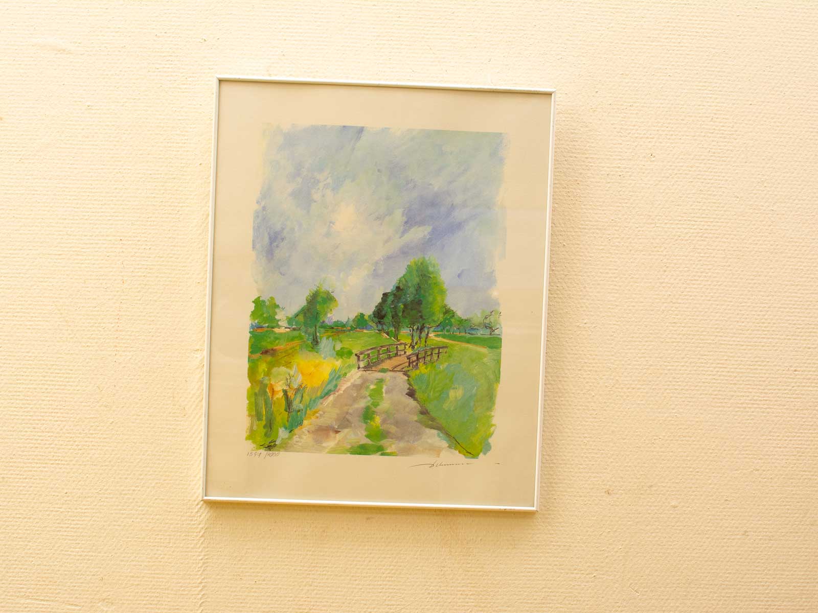 Serene watercolor countryside with winding path, rustic bridge, and vibrant wildflowers.