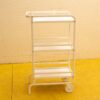 Sleek white metal cart with three shelves for versatile storage and display in any space.